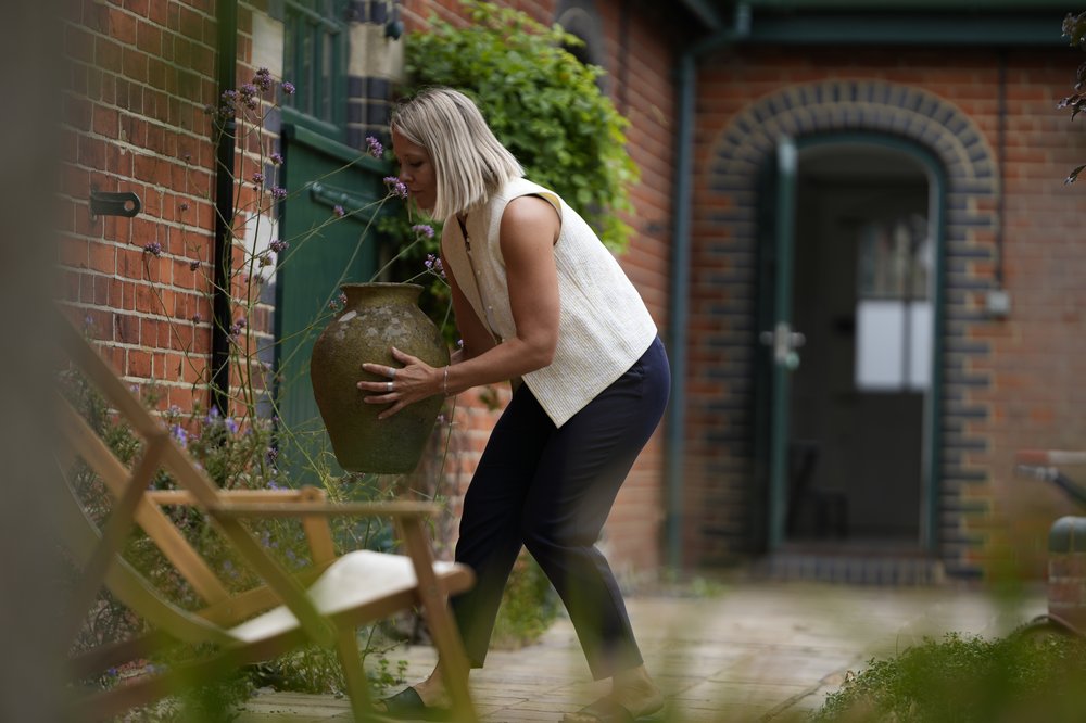 Frederica decluttering and styling a courtyard space, home stylist at work