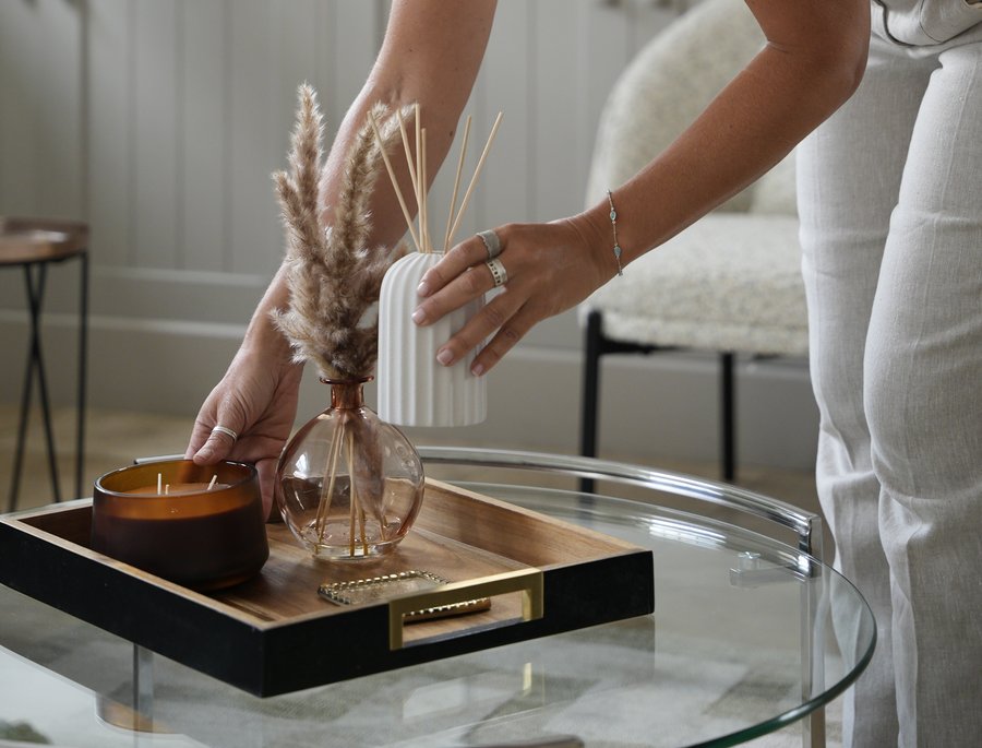 Styling a tray with candles and vases, hands-on home organising