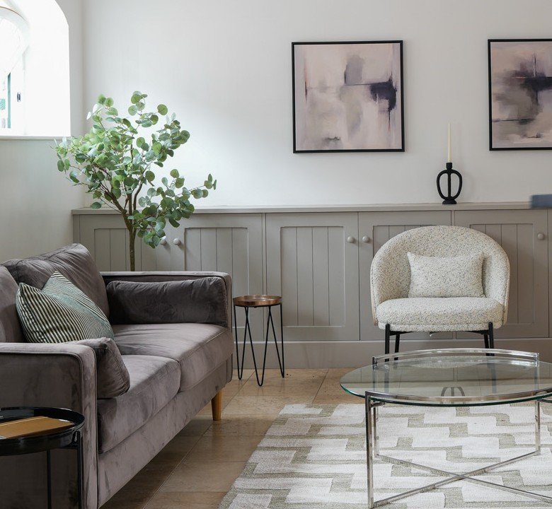 Cosy boucle armchair beside a styled potted plant